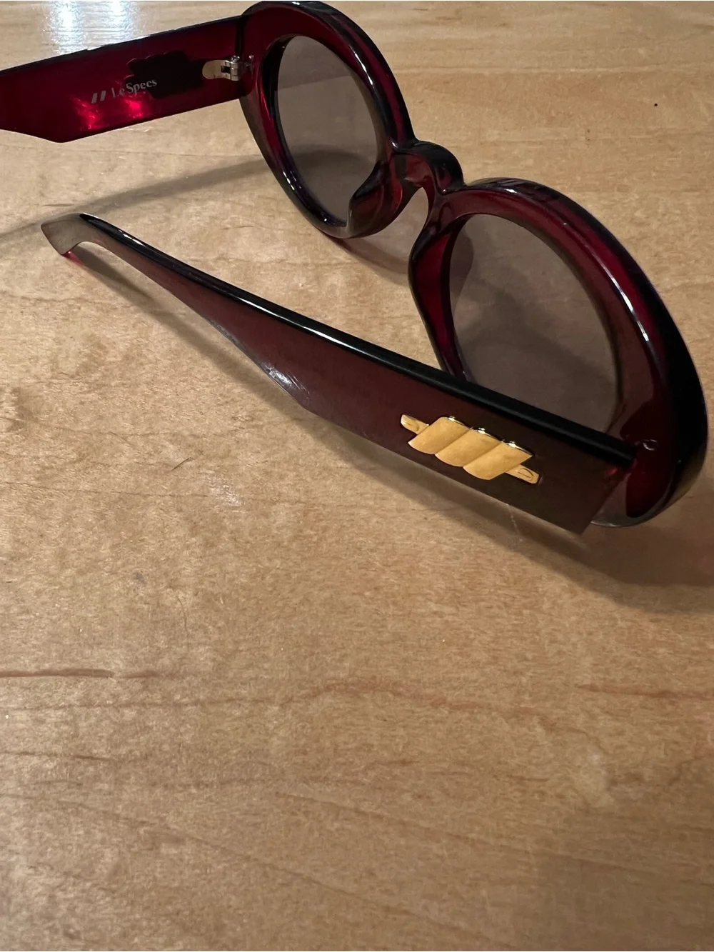 Le Specs Burgundy Oval Sunglasses with Dark Lenses